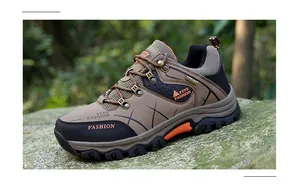 Close-up of hiking shoes with MD non-slip soles on a rocky outdoor background