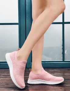 Pink breathable slip-on walking shoes with white MD sole shown on wooden floor