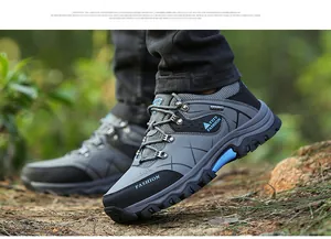 Macro view of men's hiking shoes showing anti-slip rubber outsole on forest ground