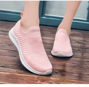 Close-up of pink slip-on breathable mesh sneakers for women with white non-slip thick sole