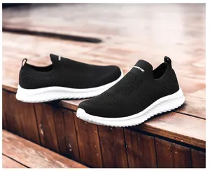Detailed close-up of breathable black knit mesh upper on lightweight slip-on sports sneakers