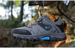 Detailed view of durable hiking shoe with non-slip rubber sole and grey mesh fabric