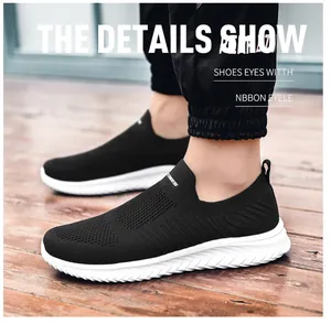 Detail view of black breathable mesh slip-on shoes with lightweight white sports soles