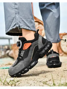 Detail of safety shoe featuring BOA-style dial lacing system and reflective accents