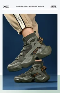 On-foot shot of olive green high-top knit sock sneakers with orange geometric details