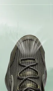 Detail of breathable fly-knit mesh fabric and woven laces on green running shoes