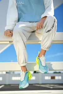 Outdoor shot of gradient sports sneakers with dial lacing system and joggers