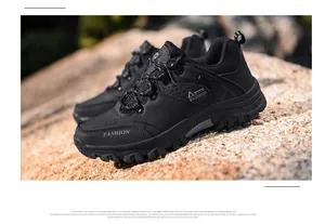 Detail of black outdoor hiking shoes featuring durable MD sole and mesh texture
