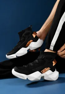 Detailed side view of black knit high-top sock sneakers with a chunky white treaded sole