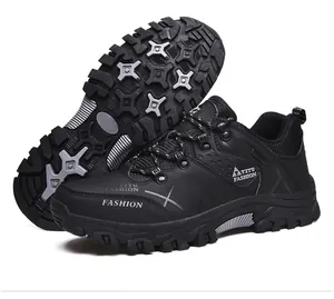 Detail view of the deep-tread anti-slip rubber outsole on black outdoor hiking shoes