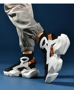 Detail of high-top sock sneaker showing chunky white geometric sole and woven fabric textures