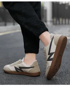 Detail view of vintage low-top sneakers with beige patchwork and gum rubber sole