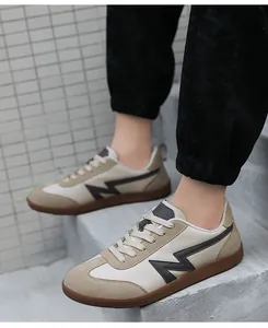 Side view of beige and grey casual sneakers with rubber soles on concrete steps