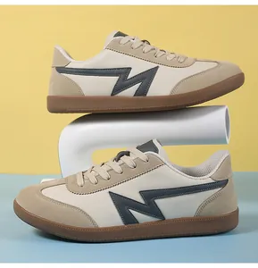 Detail view of retro unisex trainers with suede panels and classic gum rubber soles