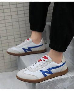 Detail shot of retro low-top sneakers with blue lightning logo and brown rubber sole