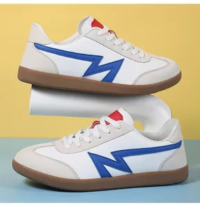 Macro detail of retro sneakers featuring blue leather accents and brown rubber soles