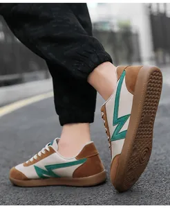Detail shot of the retro low-top sneaker featuring brown suede and green Z-shaped pattern