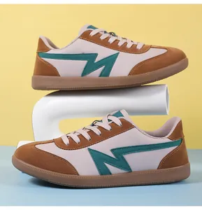 Detail of retro sneakers showing brown suede texture and green lightning logo design