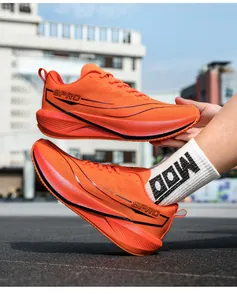Close-up of bright orange mesh running shoe with black 9PRO text on a thick sole