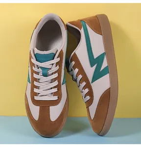Detailed side view of vintage training shoes featuring brown suede and green accents