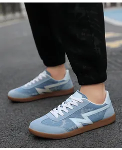 Close-up of light blue canvas sneakers with suede accents and durable gum soles