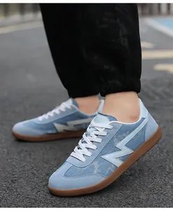 On-foot view of light blue denim casual sneakers with classic brown gum rubber soles