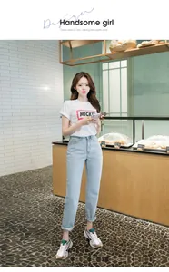 Women's vintage white T-shirt with Mickey print paired with light blue straight jeans