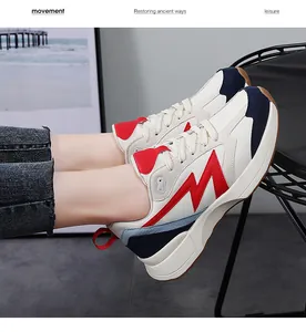 Close-up of retro low-top sneakers with red M logo and chunky sole worn by model