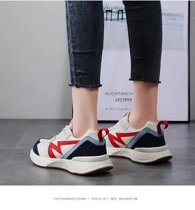 Detailed side view of women's chunky retro sneakers with red M-motif and color block panels
