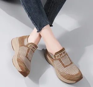 Top-down view of tan breathable knit sneakers with a thick cushioned platform sole