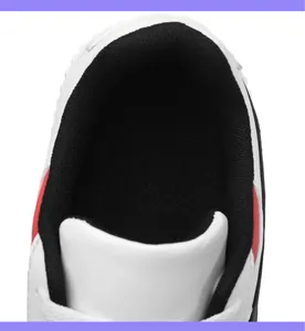Λεπτομέρεια λευκού δερμάτινου sneaker με μαύρη διχτυωτή επένδυση και καθαρές ραφές