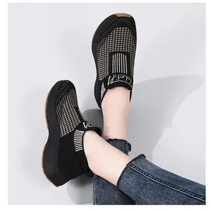 Close-up of women's knitted sock sneakers featuring textured check pattern and thick rubber sole