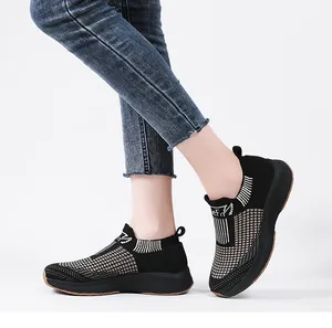 Detail of black breathable knit upper with white checkered pattern on women's sock sneakers