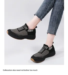 Close-up of black and white knit sneakers with thick soles and non-slip rubber outsoles