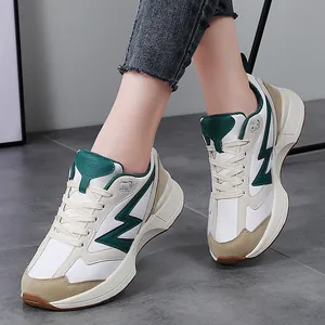 Retro low-top white sneakers with green lightning logo and khaki suede accents