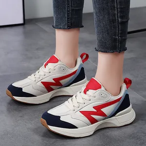 Retro color-block low-top sneakers for women featuring a bold red lightning side logo