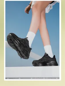 Dynamische lage hoekopname van zwarte chunky sneakers met ademende mesh panelen