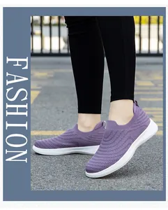 Detail of purple slip-on walking shoes featuring breathable knitted mesh and white sole