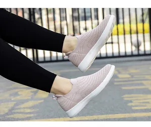 Detail of pink knitted slip-on walking shoe with breathable mesh and white thick sole