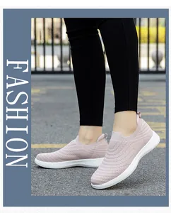 Outdoor shot of pink slip-on walking shoes with breathable knit upper and thick white sole