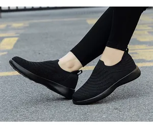 Close-up of black slip-on walking shoes with breathable knitted fabric texture