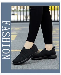 Close-up of black breathable slip-on walking shoe with knitted texture and heel pull tab