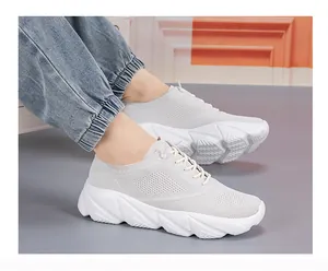 Side view of light gray breathable mesh sneakers with white thick anti-slip sole on foot
