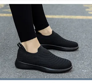 Close-up of black breathable slip-on walking shoes for elderly on outdoor asphalt