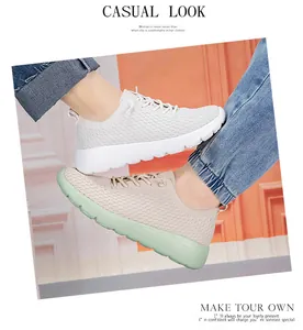 On-foot shot of breathable knit mesh casual sneakers in white and mint green styles