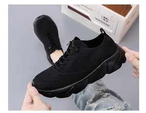 Detail view of black fly-knit breathable mesh sneaker with thick cushioned sole