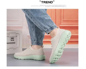 Detail view of beige breathable knitted upper and pale green non-slip sole on feet