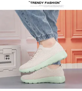 Detailed close-up of breathable knit mesh upper on beige and mint green sports sneakers