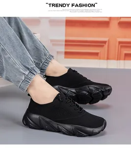 Detail showing breathable knitted mesh texture and thick serrated sole of black sports sneakers