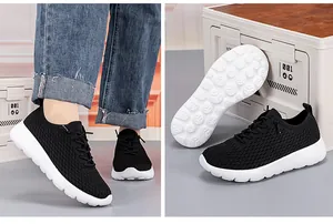 Detail of black mesh sneakers showing non-slip sole and drawstring lace buckle